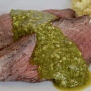 Tri-tip cooked medium rare topped with pesto and served with creamy pesto pasta.