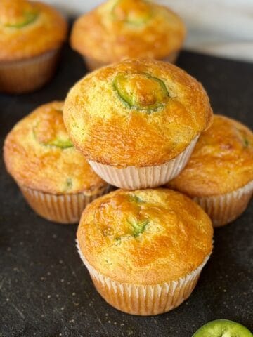jalapeño cheddar cornbread muffins on black cutting board