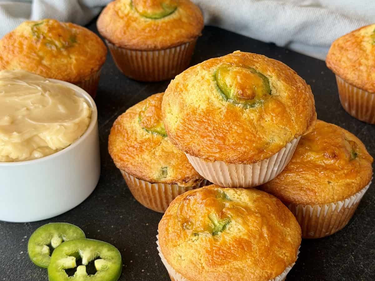 jalapeño cheddar cornbread muffins on black cutting board