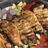 grilled chicken on grill pan with bell peppers, red onion, zucchini, and mushrooms