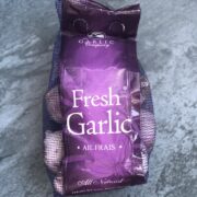 2 pound bag of garlic on blue background