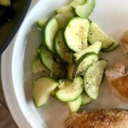 plate with cooked zucchini and roasted chicken