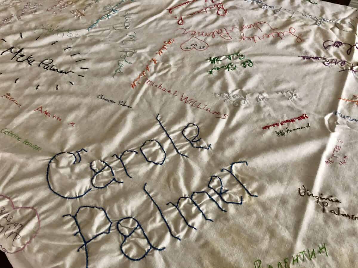 several colorful signatures on a very old and dingy table cloth