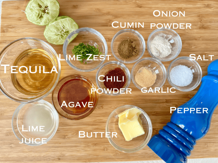 tequila lime chicken wing sauce ingredients in small glass bowls on a wood cutting board