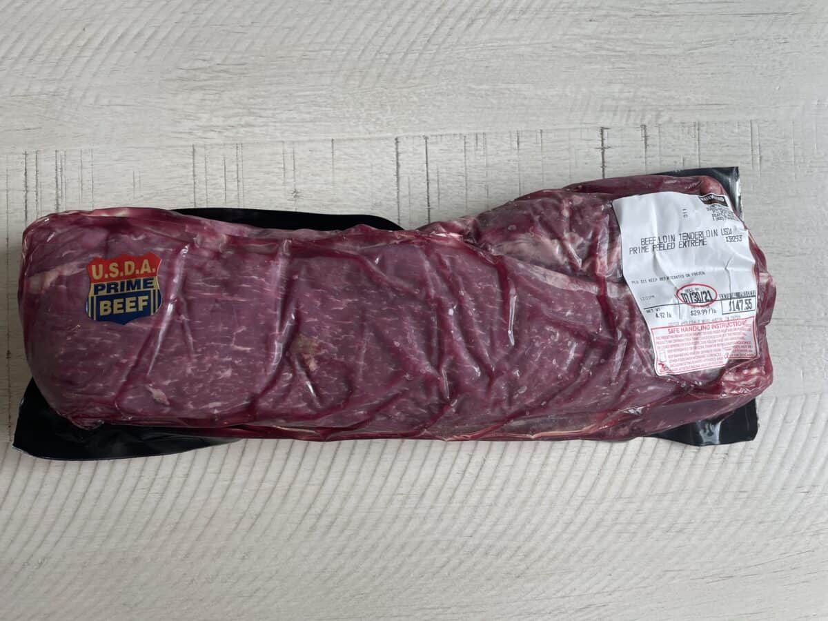 a sealed and packaged prime beef tenderloin from costco with the price tag on it