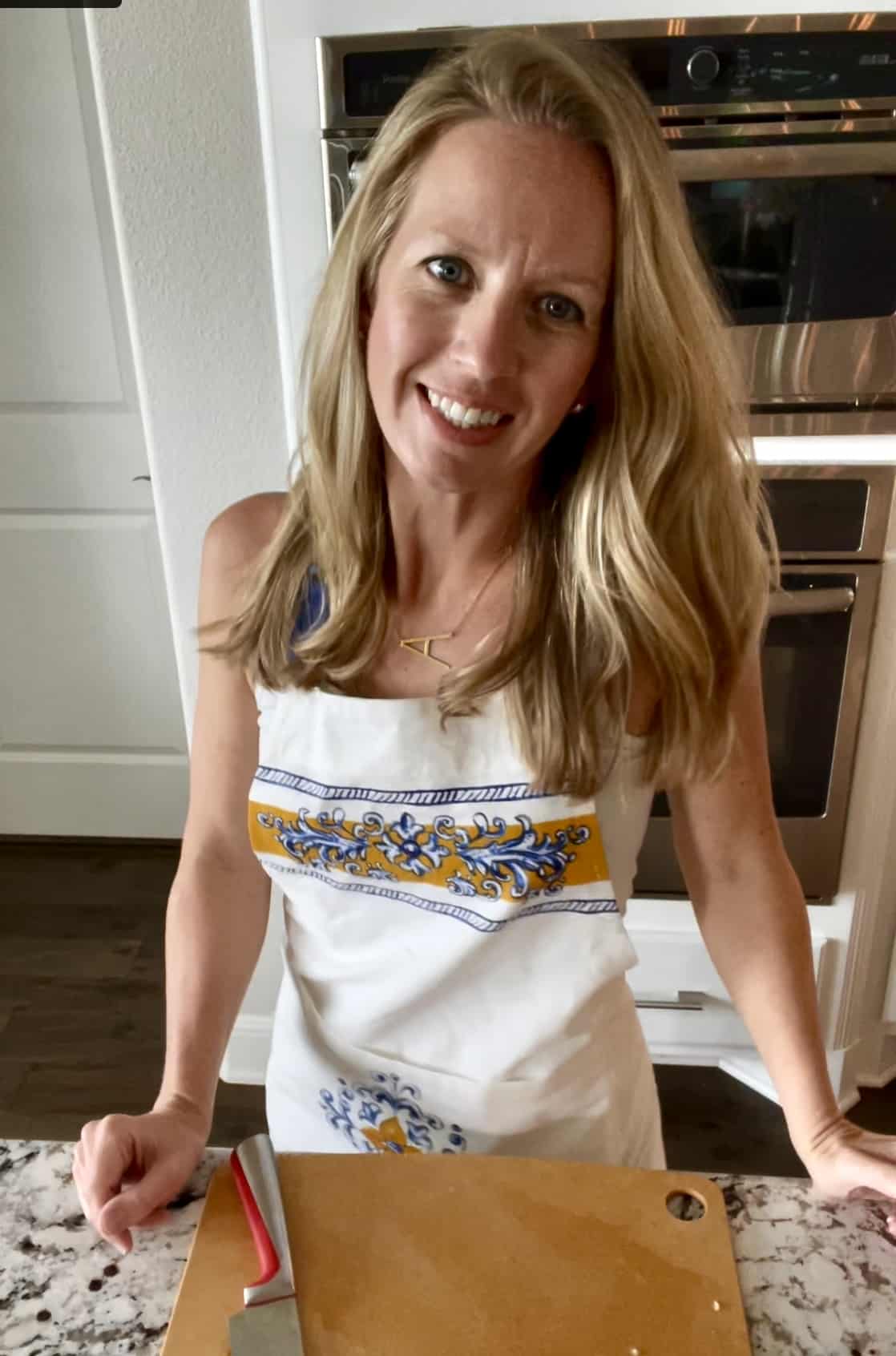 photo of Alexis standing in her kitchen with a latin inspired apron on