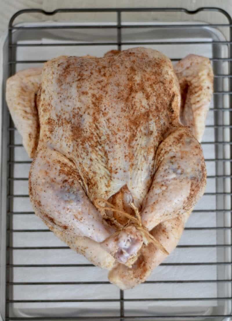 https://fancyaproncooking.com/wp-content/uploads/2022/01/traeger-whole-chicken-after-seasoning-1-e1641326543504.jpg