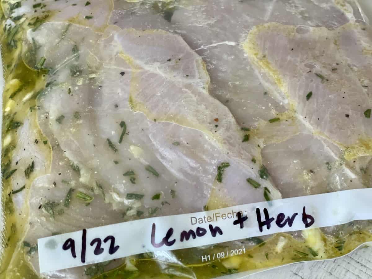 chicken in a vacuum sealed pouch in lemon and harb marinade