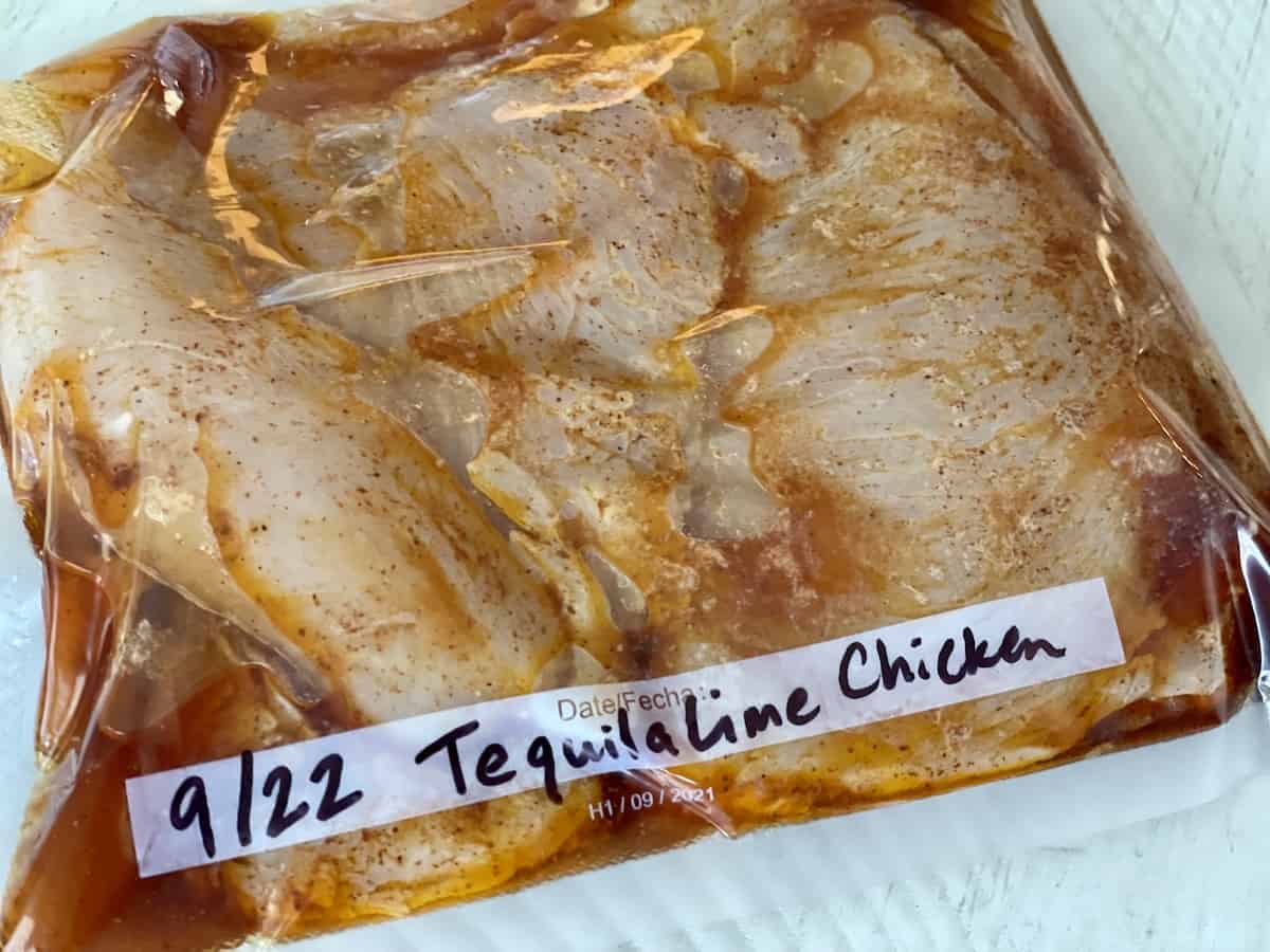 chicken marinating in a vacuum sealed package with tequila lime marinade