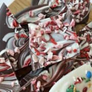 a pile of dark and white chocolate peppermint christmas bark in all sorts of shapes