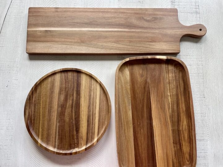 1 rectangular charcuterie board with a handle one round charcuterie board and one oval shaped wood board