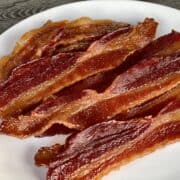 cooked bacon jerky laid on a white plate