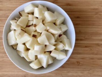 small diced russet potatoes in a white bowl