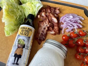 copycat Outback Steakhouse wedge salad ingredients on a wood cutting board