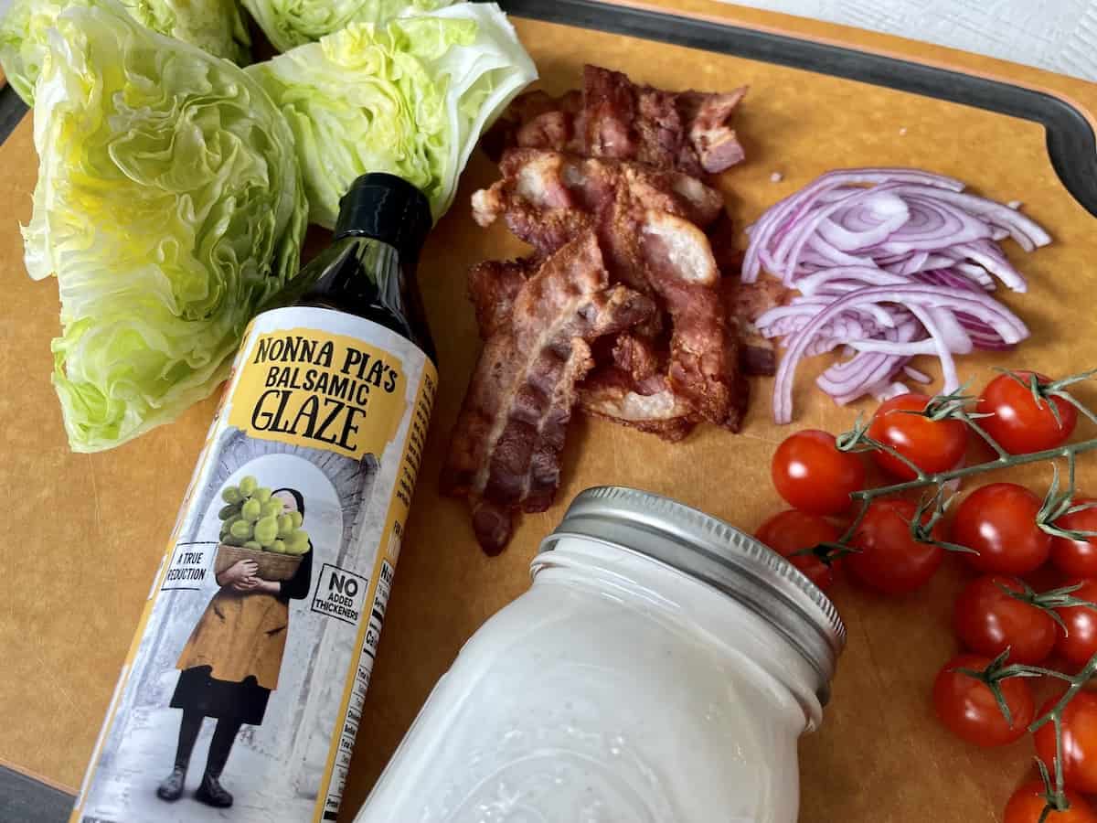 copycat Outback Steakhouse wedge salad ingredients on a wood cutting board