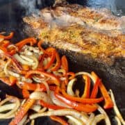 Traeger flatrock fajitas cooking on a Traeger flatrock