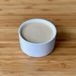 white bowl of hibachi mustard sauce on wood cutting board