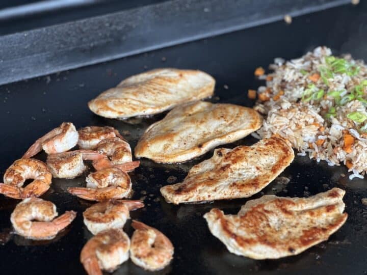 hibachi chicken and shrimp cooking on Traeger flat rock