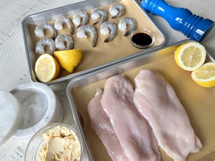 metal trays with prepared hibachi ingredients shrimp lemons soy sauce chicken breast hibachi butter