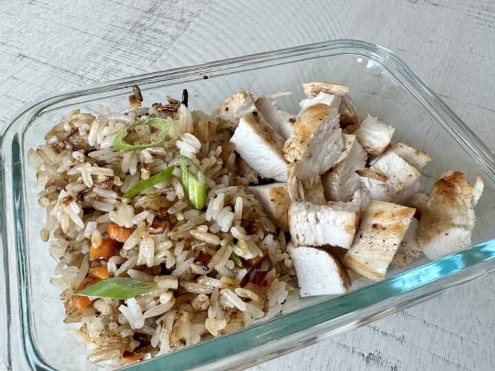 glassware container of chicken and fried rice