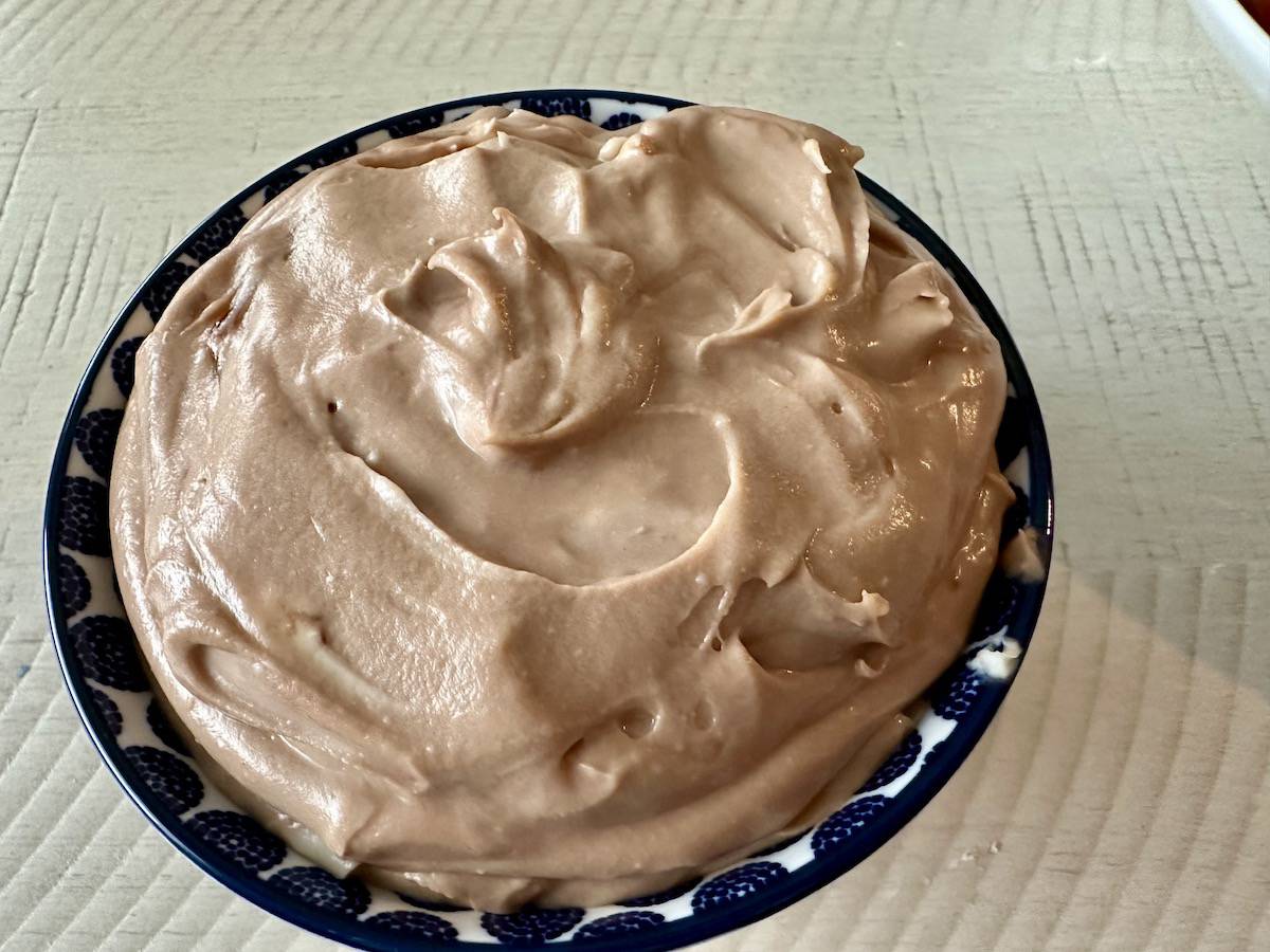 chocolate cheesecake dip in blue bowl white kitchen table