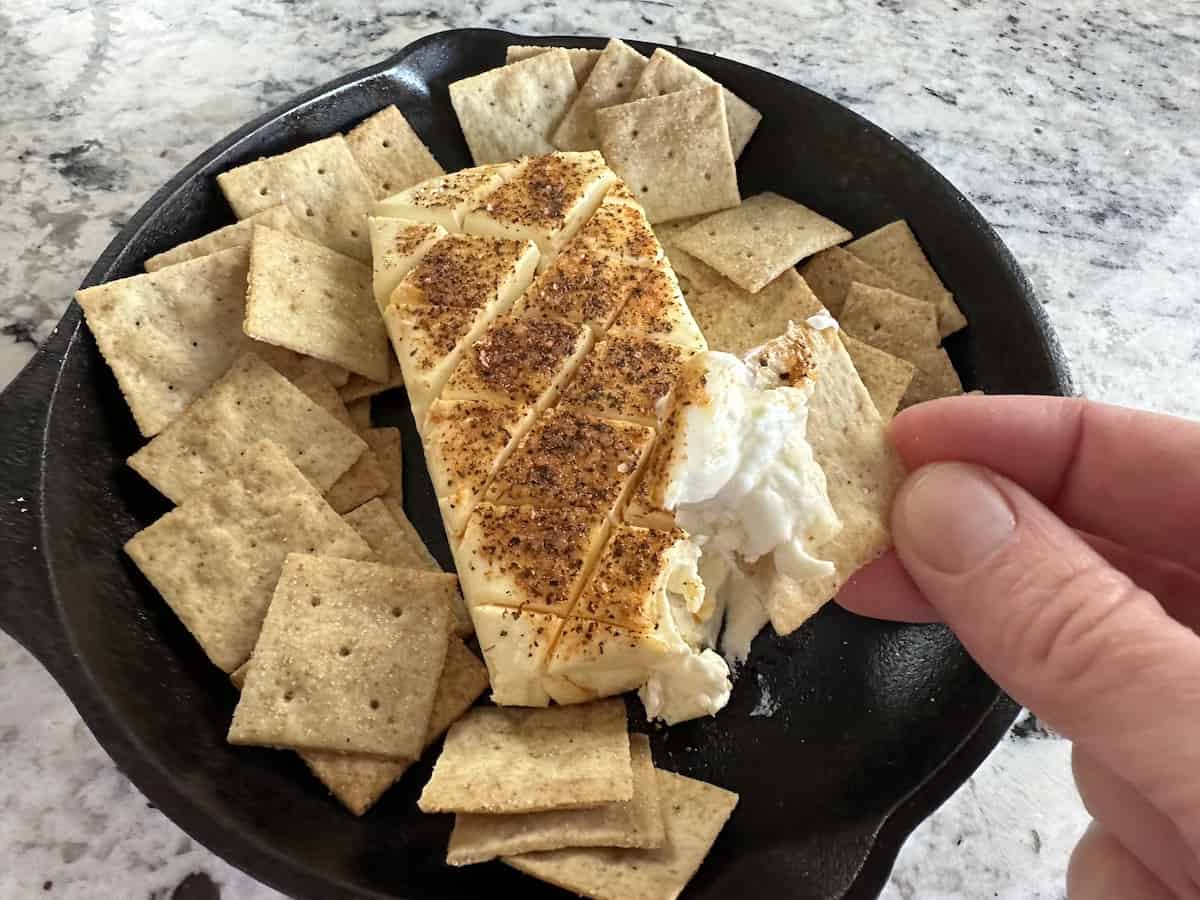 square cracker scooping into smoked cream cheese dip