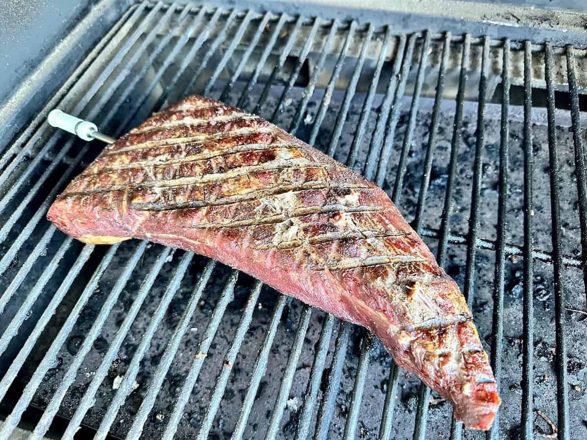 cooked Tri Tip on traeger grill grates with armeator thermometer