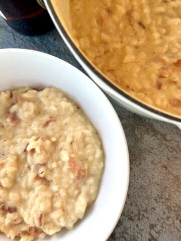white bowl of beer cheddar bacon risotto white pot of cooked risotto