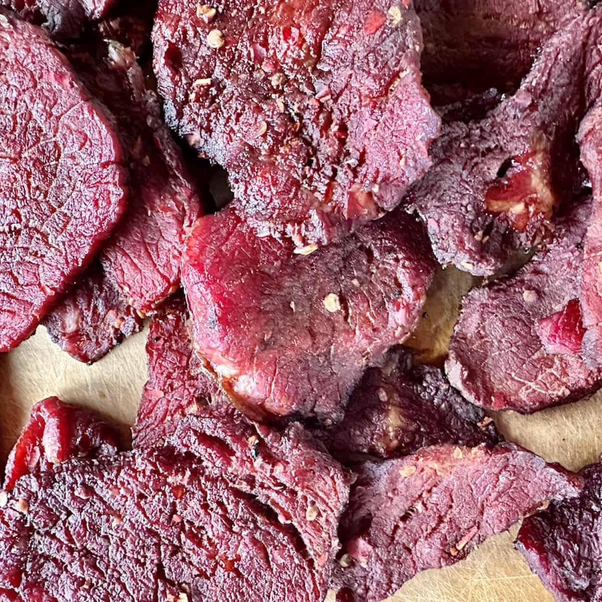 pile of chili lime beef jerky on brown cutting board