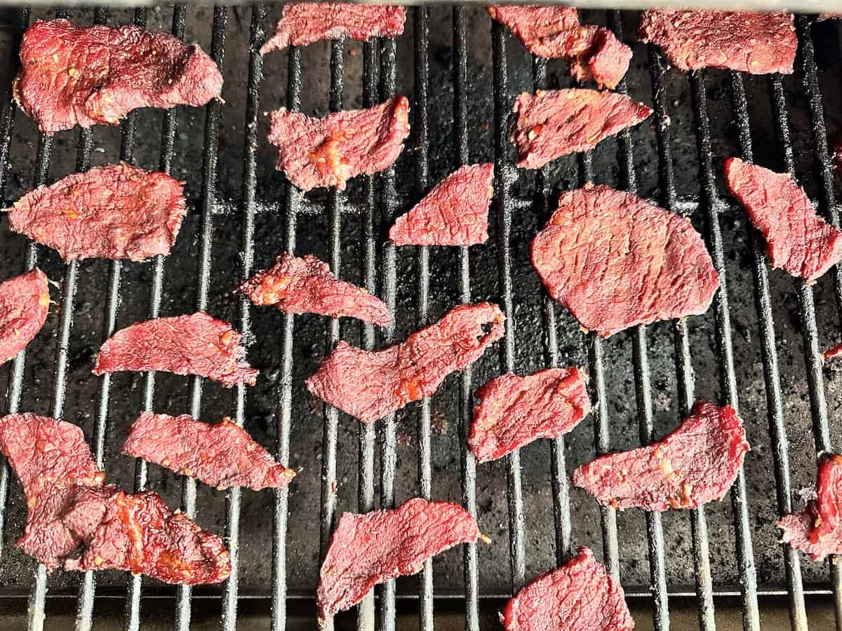 slices of chili lime beef jerky on Traeger grill grates