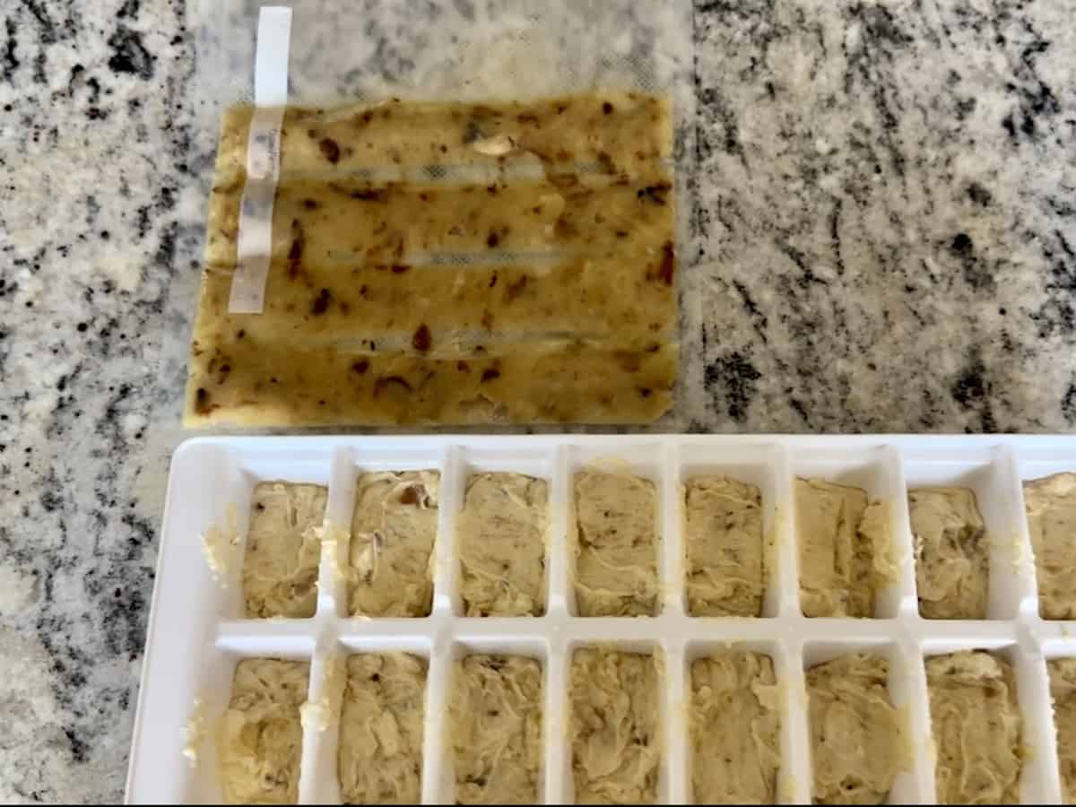 food saver bag of smoked garlic and ice cube tray filled with garlic butter