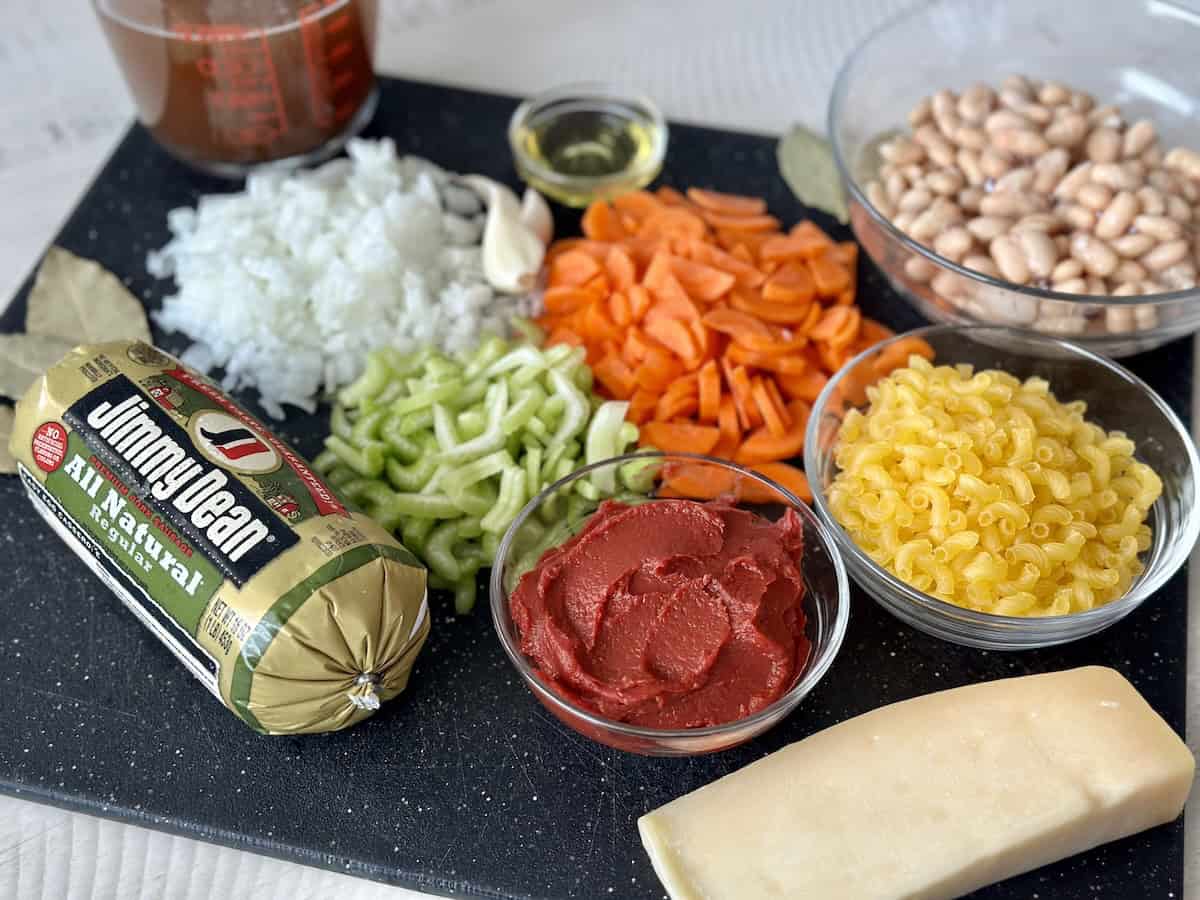 soup ingredients in glass bowls on black cutting board