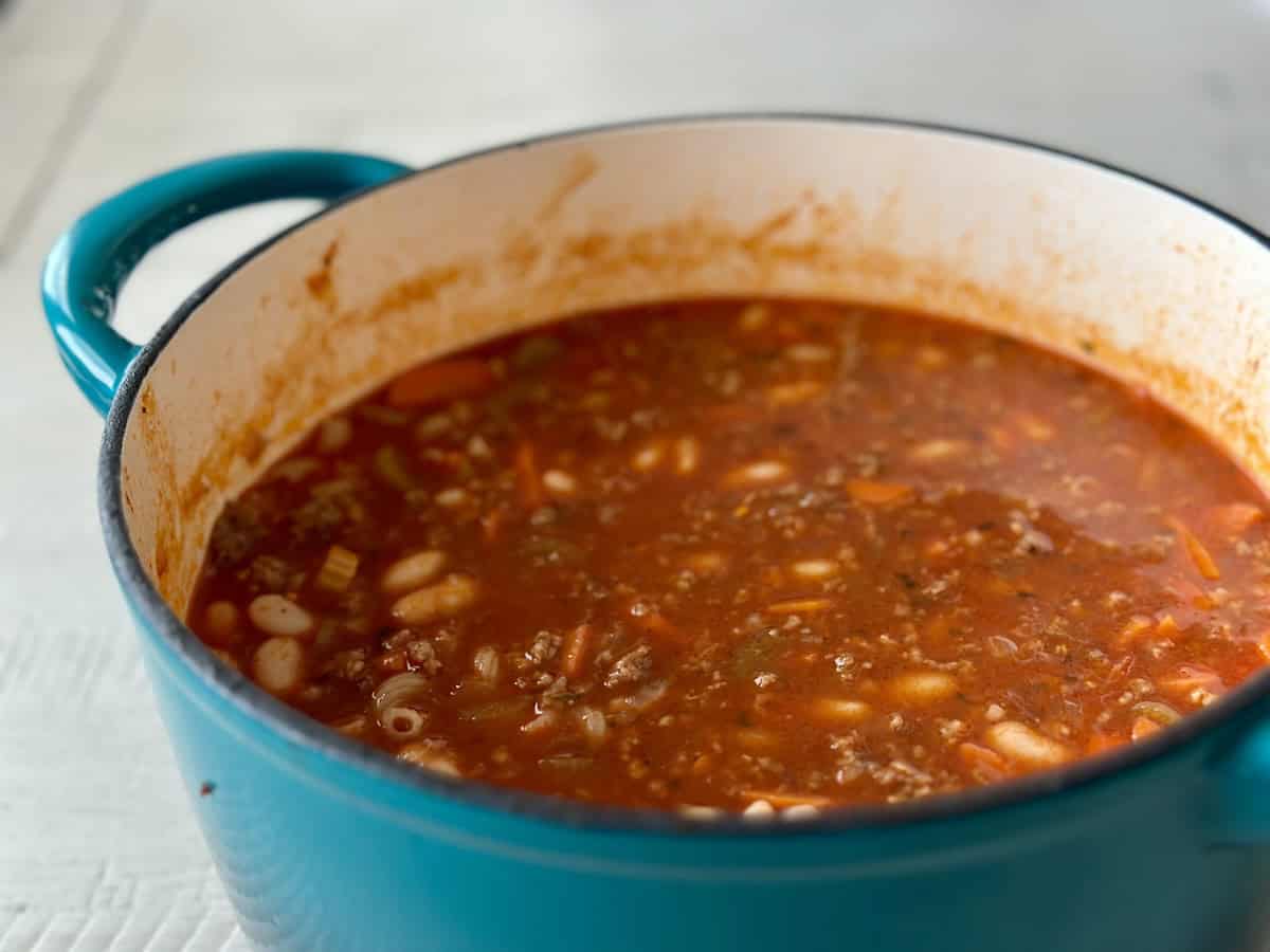 teal enabled cast iron pot with pasta e fagioli soup