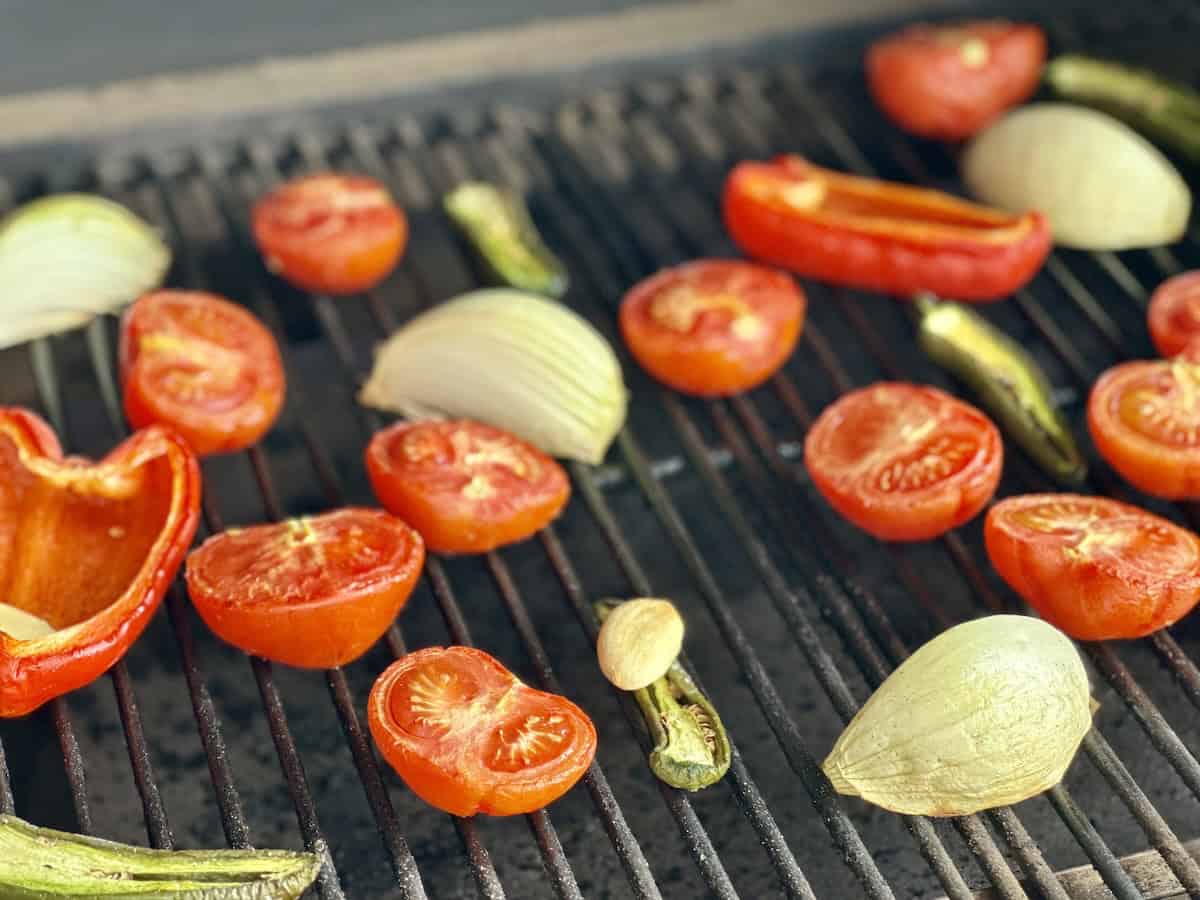 cut salsa vegetables on grill grates of smoker