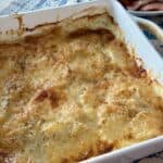 au gratin potatoes in white ceramic baking dish on kitchen table
