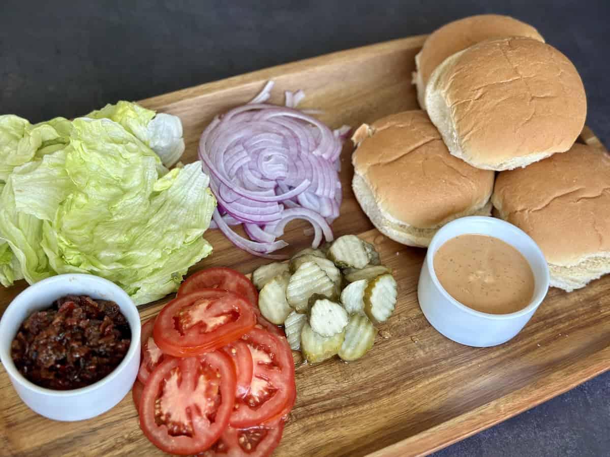 burger toppings on wood board