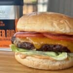 smoked cheeseburger on wood cutting board traeger rub