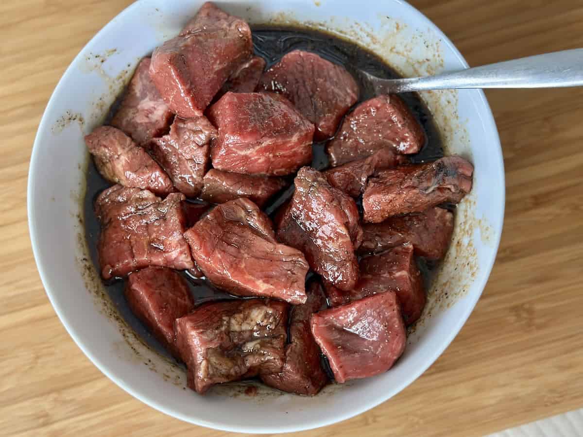 white bowl of steak and basic meat marinade