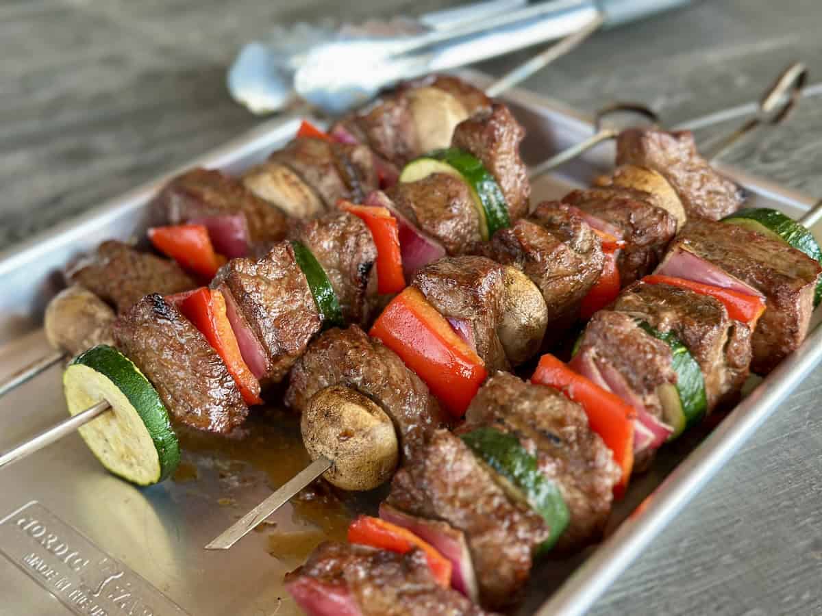 marinated steak kabobs on metal tray