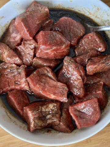 white bowl of steak and basic meat marinade