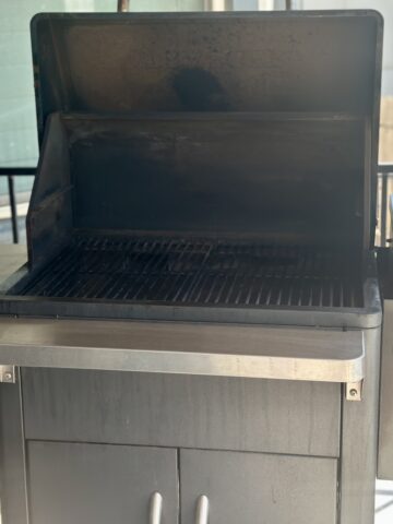Traeger grill with lid open on patio
