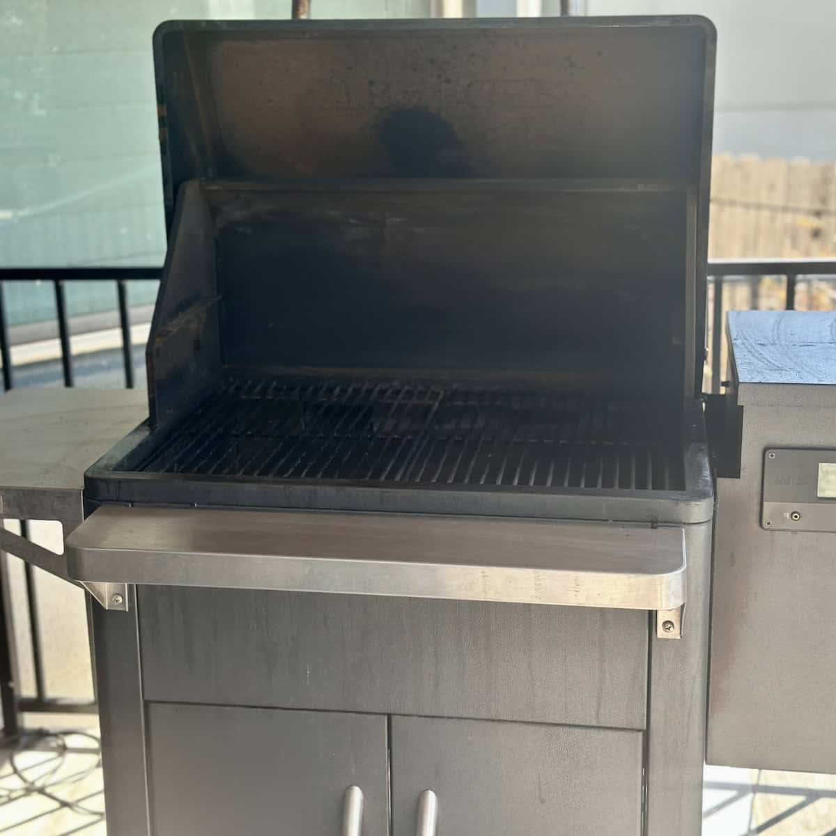 Traeger grill with lid open on patio