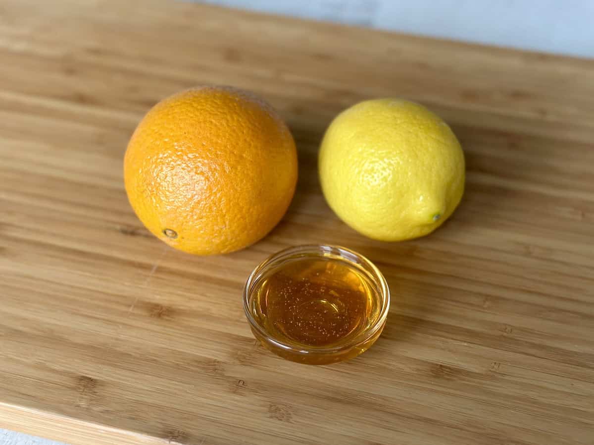 honey orange lemon on wood cutting board
