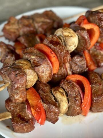 grilled traeger steak kabobs on white plate