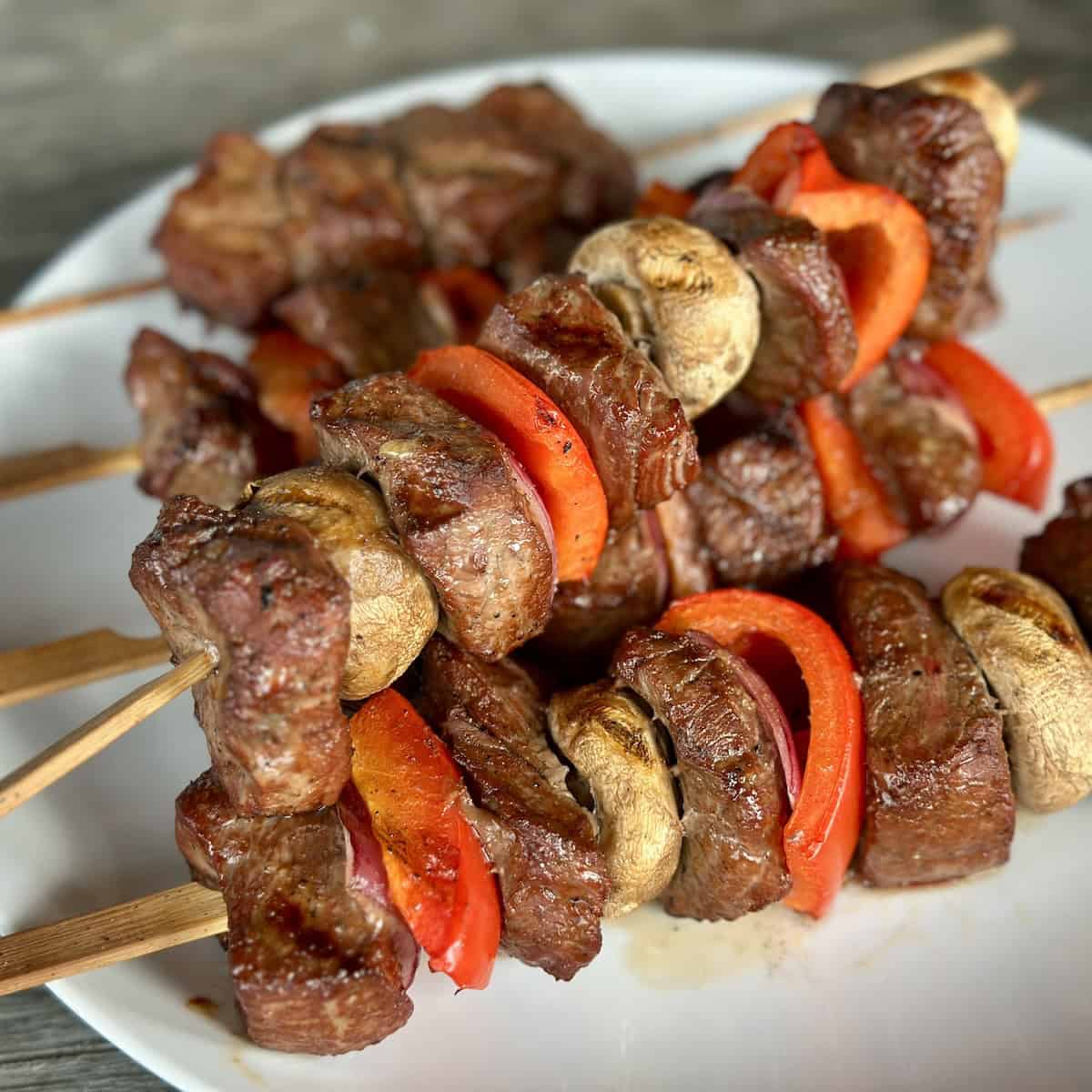 grilled traeger steak kabobs on white plate