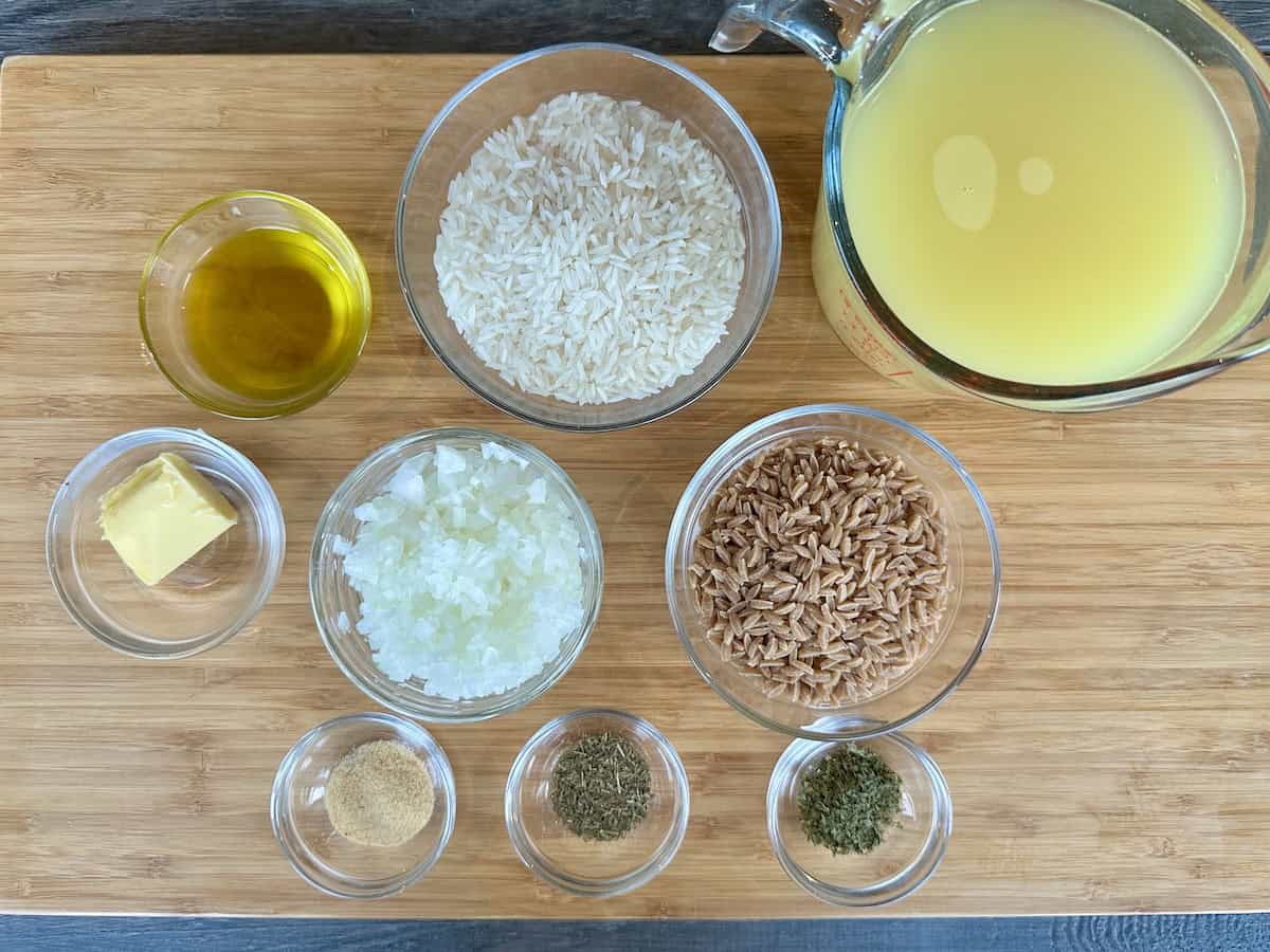 rice pilaf with orzo ingredients in glass bowls on wood cutting board