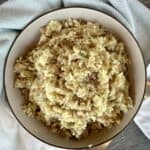 rice pilaf in brown bowl green kitchen towel
