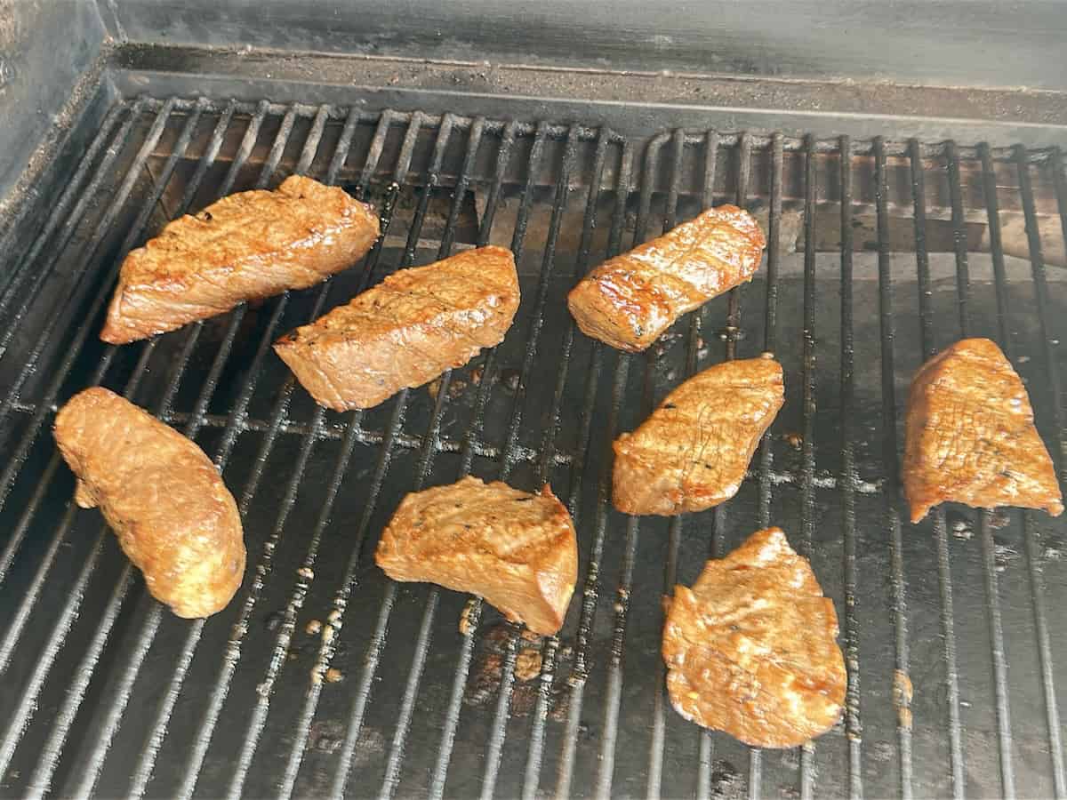 tri-tip steaks cooking on grill