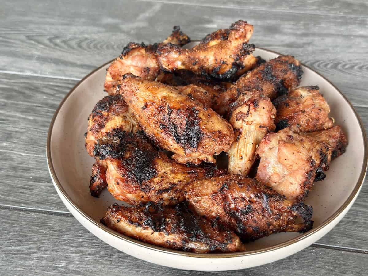 cooked dry rubbed chicken wings on white plate