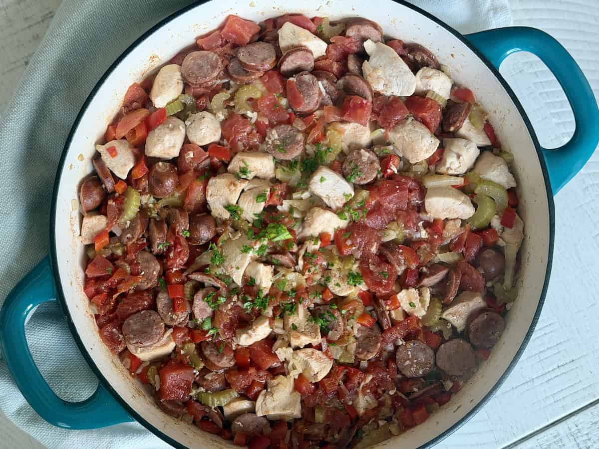 teal cast iron pan with chicken and sausage jambalaya 